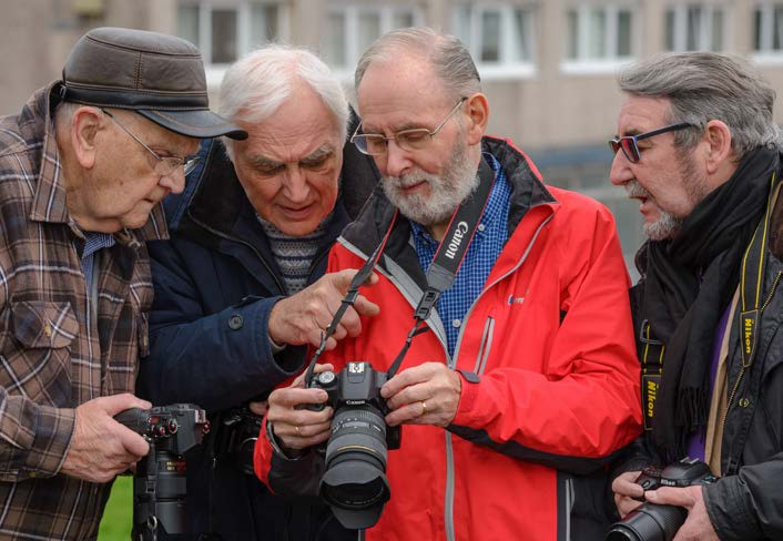 four gentlemen looking at a camera